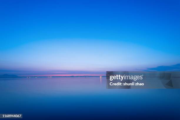 the calm sea at sunrise - sunrise over water stock pictures, royalty-free photos & images