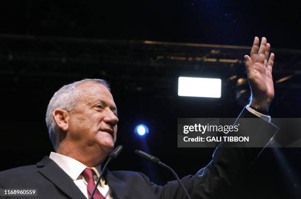 Benny Gantz, leader and candidate of the Israel Resilience party that is part of the Blue and White political alliance, waves as he addresses...