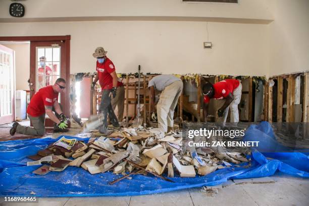 Members of Sheep Dog Impact Assistance clean debris and demolish portions of the Tabernacle Baptist Christian Academy and Church in the aftermath of...