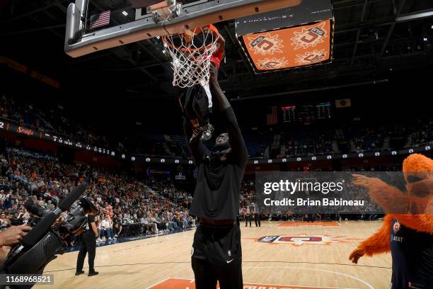 Tacko Fall of the Boston Celtics helps a baby shoot the ball during the halftime between Los Angeles Sparks and the Connecticut Sun on September 17,...