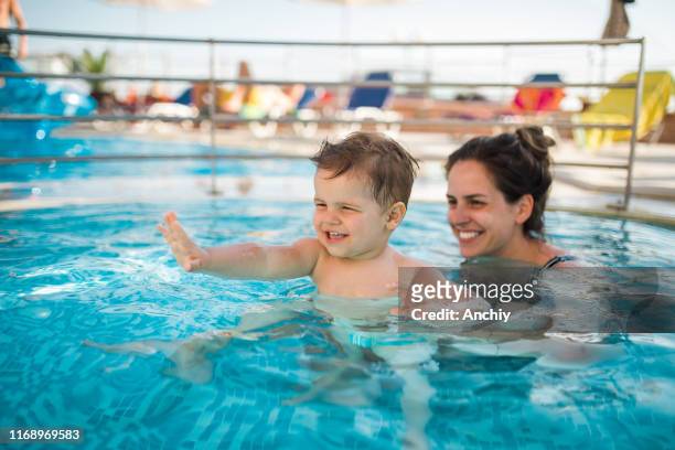 mother and baby in swimming pool - baby bath stock pictures, royalty-free photos & images