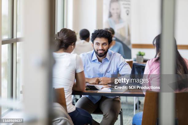 confident male bank officer discusses loan with clients - credit union stock pictures, royalty-free photos & images