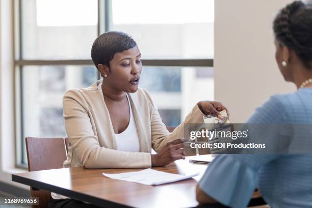 bank employee talks with potential customer - pamphlet stock pictures, royalty-free photos & images