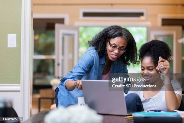 mature mom helps her daughter study - university student support stock pictures, royalty-free photos & images