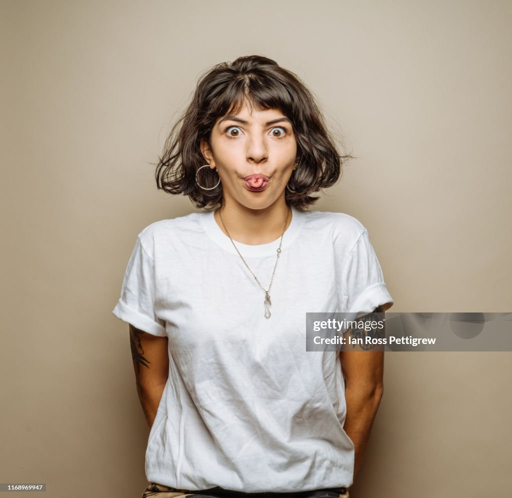 Cute young woman making a face