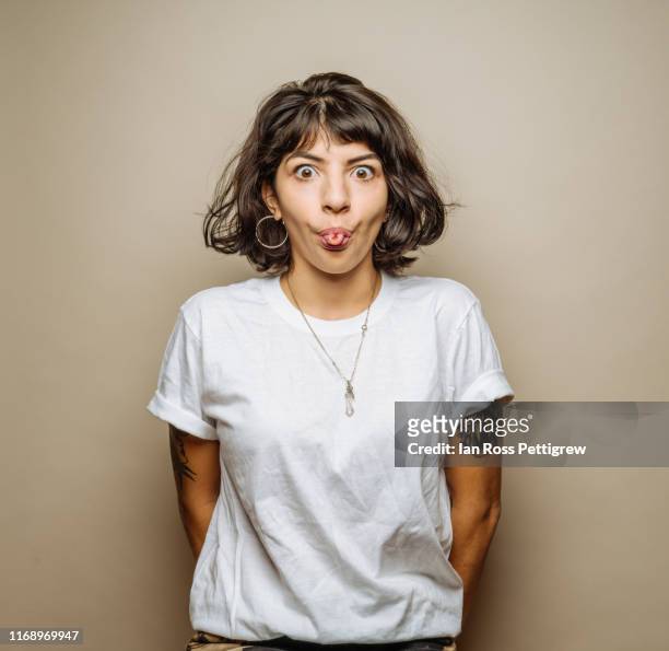 cute young woman making a face - t shirt stock pictures, royalty-free photos & images