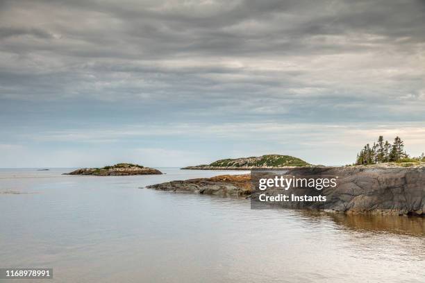 ragueneau archipelago with its small islands on quebec north coast, north coast, as seen from the dock. - quebec landscape stock pictures, royalty-free photos & images