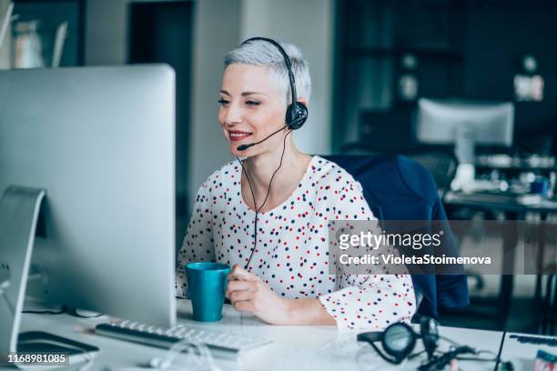 happy call center operator - happy consumer on phone stock pictures, royalty-free photos & images