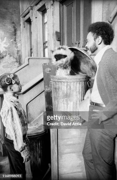 Actor Matt Robinson talks to muppet Oscar the Grouch as a child looks on during the taping of an episode of Sesame Street at Reeves TeleTape Studio...