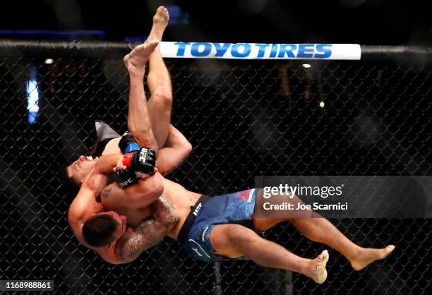 Christos Glagos is slammed onto the ground by Drakkar Klose in the third round during their Lightweight Bout at UFC 241 at Honda Center on August 17,...