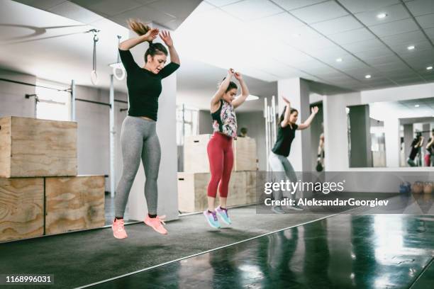 jumping jacks in gym - jumping jack stock pictures, royalty-free photos & images