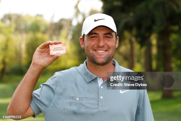 Scottie Scheffler holds up his PGA Tour card during the "The 25" ceremony after the final round of the WinCo Foods Portland Open presented by...