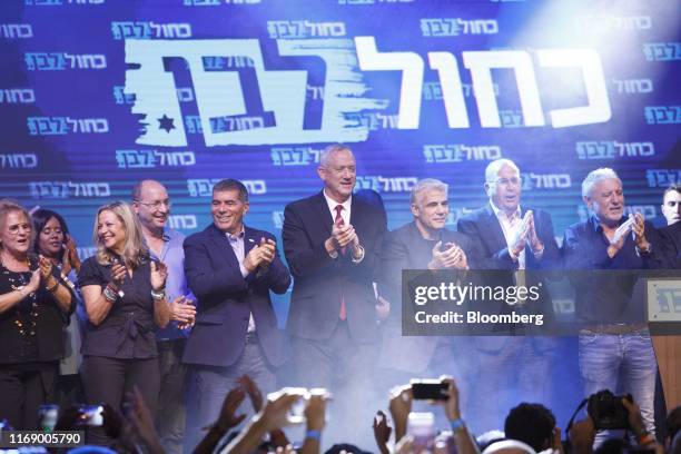 Benny Gantz, leader of the Blue and White party, fourth right, applauds as he stands with party members in Tel Aviv, Israel, on Wednesday, Sept. 18,...