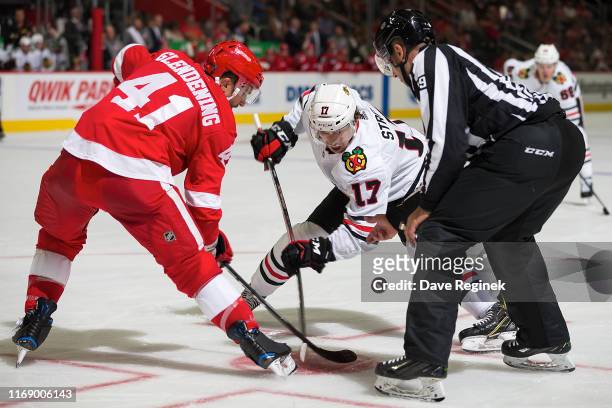 Luke Glendening of the Detroit Red Wings faces off against Dylan Strome of the Chicago Blackhawks during a pre-season NHL game at Little Caesars...