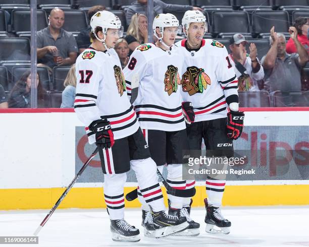 Dominik Kubalik of the Chicago Blackhawks celebrates his second period goal with teammates Dylan Strome and Brendan Perlini during a pre-season NHL...