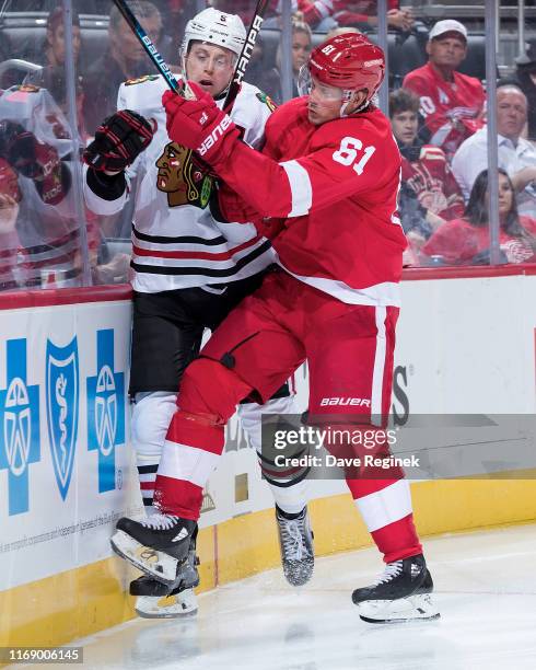 Jacob de la Rose of the Detroit Red Wings checks Connor Murphy of the Chicago Blackhawks during a pre-season NHL game at Little Caesars Arena on...