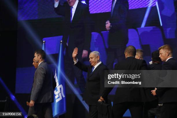 Benjamin Netanyahu, Israel's prime minister, center, waves to attendees as he leaves the stage at Likud party headquarters in Tel Aviv, Israel, early...