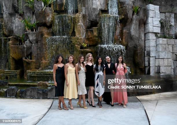 This picture taken on September 17, 2019 shows Miss World contestants from 2015, from Narissara Nena France of England, Vanessa Tevi of Malaysia,...