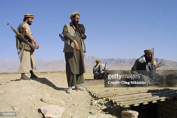 Northern Alliance soldiers stand guard at position near the front line in the province of Kapissa October 13, 2001 in Northern Afghanistan....