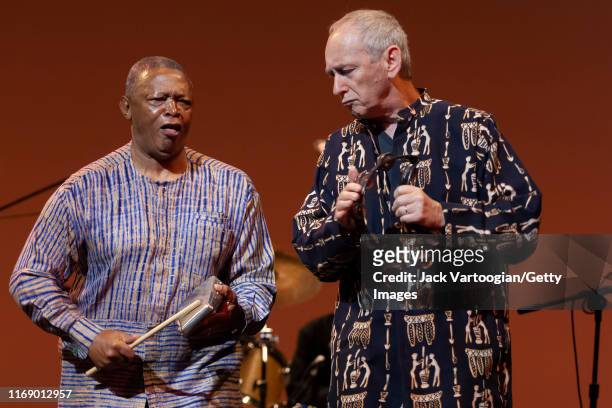 South African Jazz musician, composer, and activist Hugh Masekela and Morris Goldberg both play percussion as they perform onstage during the 'Sounds...
