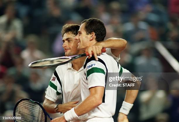 French tennis pair Henri Leconte and Guy Forget congratulate each other after defeating Israeli pair Amos Mansdorf and Gilad Bloom here 30 march 1991...