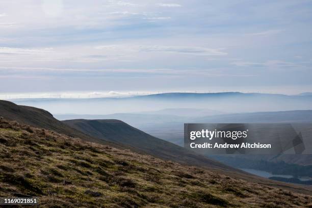 Line of wind turbines in the horizon on the top of Rhigos Hill Pass in the Cynon Valley, Rhondda Cynon Taf, South Wales, United Kingdom. There are 76...