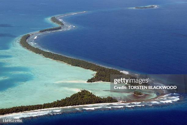 The South Pacific pounds the serpentine coastline of Funafuti Atoll, 19 February 2004, home to nearly half of Tuvalu's entire population of 11 as...