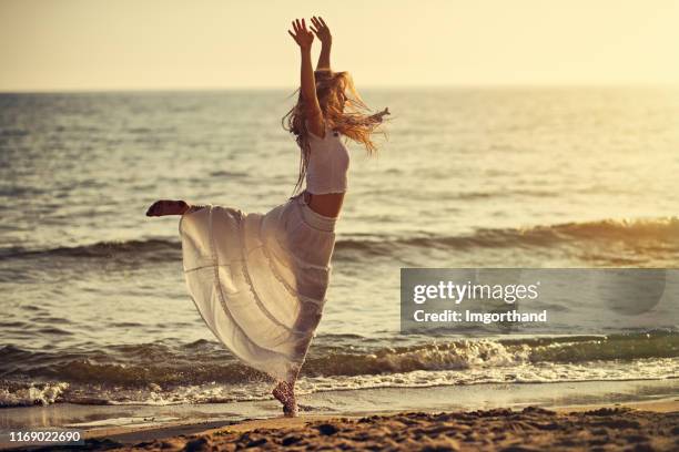 teenage girl dancing on the beach. - jazz dancing stock pictures, royalty-free photos & images