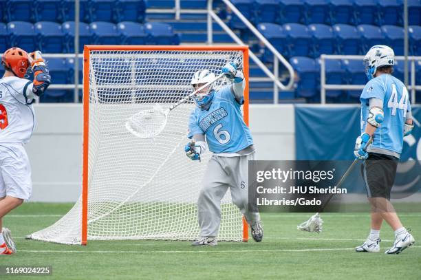 Full-length shot of a Johns Hopkins University Men's Lacrosse goaltender, catching the ball in his net during a National Collegiate Athletic...