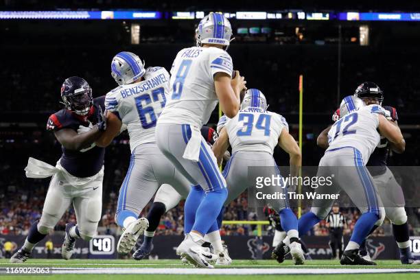 David Fales of the Detroit Lions looks to pass under pressure by Albert Huggins of the Houston Texans in the second half against the Houston Texans...