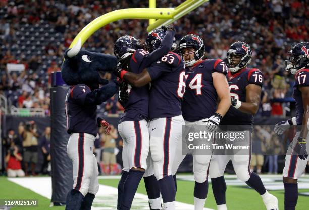 DeAndre Hopkins of the Houston Texans is congratulated by teammates after scoring a touchdown in the first quarter against the Detroit Lions during...