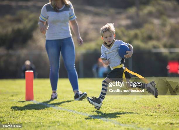 mother watching her son score a touchdown in flag football, california, united states - flag football stock pictures, royalty-free photos & images