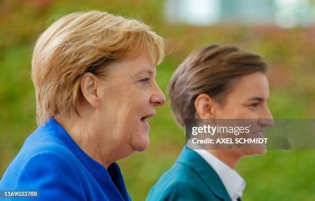 German Chancellor Angela Merkel and Serbian Prime Minister Ana Brnabic talk during a welcoming ceremony in front of the Chancellery in Berlin on...