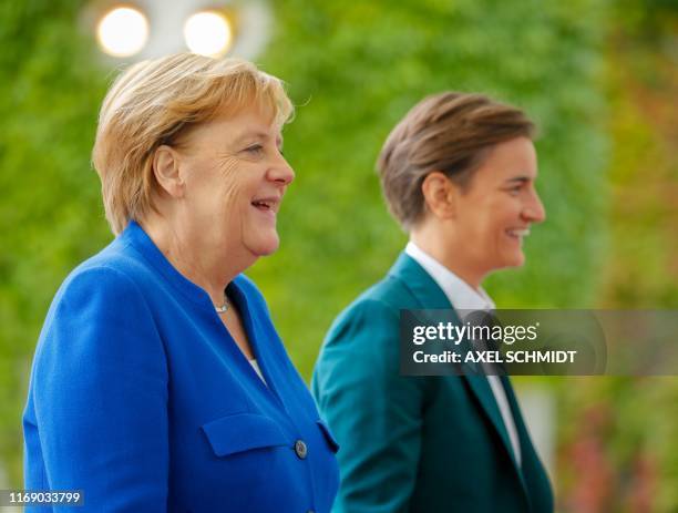 German Chancellor Angela Merkel and Serbian Prime Minister Ana Brnabic talk during a welcoming ceremony in front of the Chancellery in Berlin on...