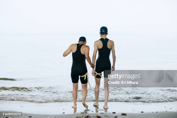 a visually impaired female triathlete and her guide at sea