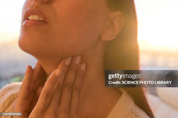 woman touching neck - human gland 個照片及圖片檔