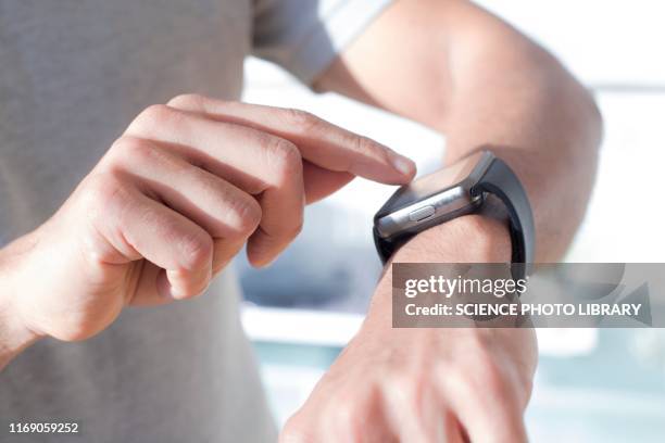 man checking his smart watch - handgelenk stock-fotos und bilder