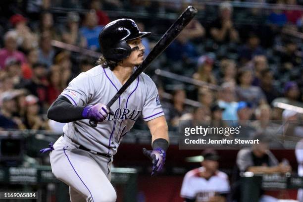 Tony Wolters of the Colorado Rockies hits an RBI single in the eighth inning of the MLB game against the Arizona Diamondbacks at Chase Field on...