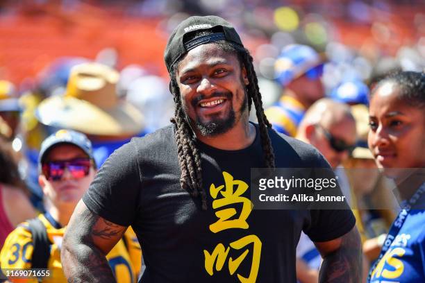 Retired NFL footballer Marshawn Lynch is all smiles before the preseason game between the Dallas Cowboys and the Los Angeles Rams at Aloha Stadium on...
