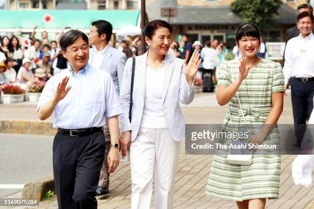 Emperor Naruhito, Empress Masako and Princess Aiko wave to well-wishers at Nasushiobara Station on their way to the Nasu Imperial Villa on August 19,...