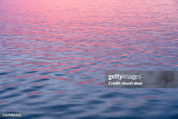 sea and wave at sunrise - red and blue design imagens e fotografias de stock