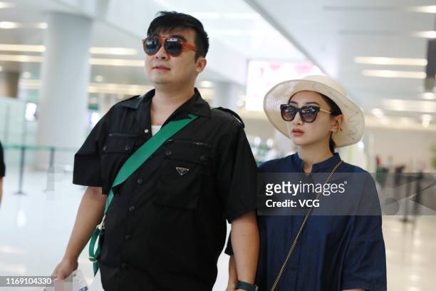 Trampoline gymnast He Wenna and her film producer boyfriend Liang Chao are seen at Shanghai Hongqiao International Airport on August 20, 2019 in...