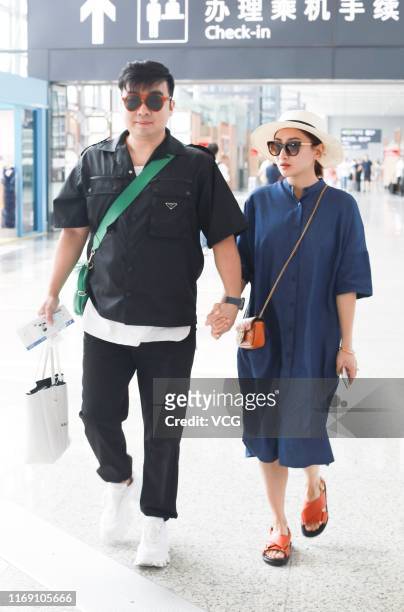 Trampoline gymnast He Wenna and her film producer boyfriend Liang Chao are seen at Shanghai Hongqiao International Airport on August 20, 2019 in...