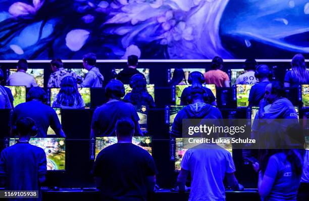 Visitors try out the latest version of Final Fantasy during the press day at the 2019 Gamescom gaming trade fair on August 20, 2019 in Cologne,...