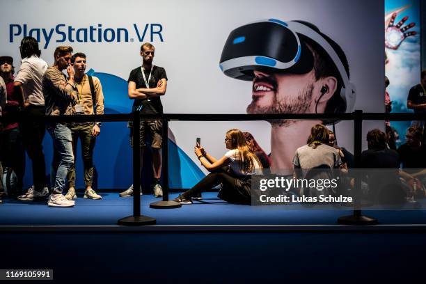 Visitors wait in front of the PlayStation VR area during the press day at the 2019 Gamescom gaming trade fair on August 20, 2019 in Cologne, Germany....