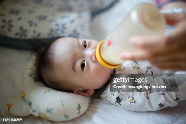 a baby drinking milk - korean ethnicity stock-fotos und bilder