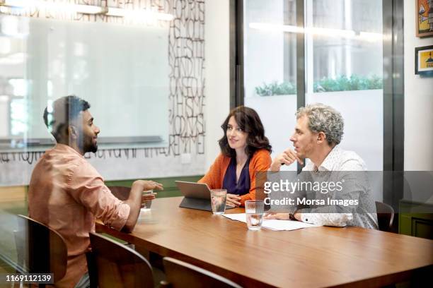colleagues discussing in meeting at office - business interview stock pictures, royalty-free photos & images