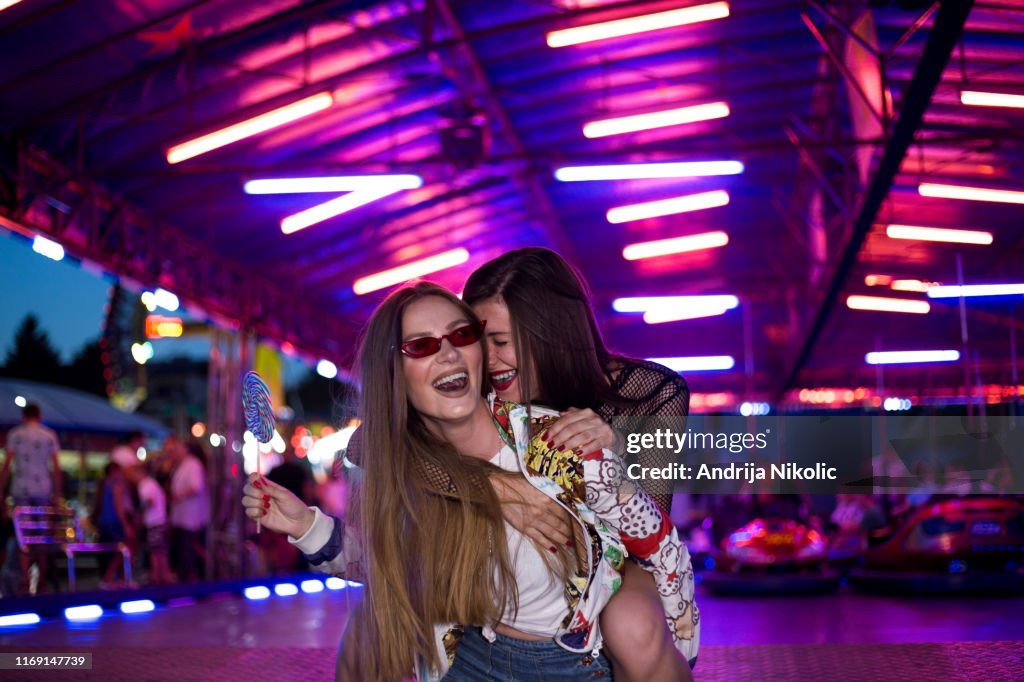Gf Ride Artist Female Friend Giving Piggyback Ride To Her Girlfriend At A Fair High ...