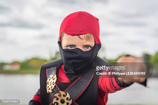 little boy dressed with a ninja costume - seven samurai stock-fotos und bilder