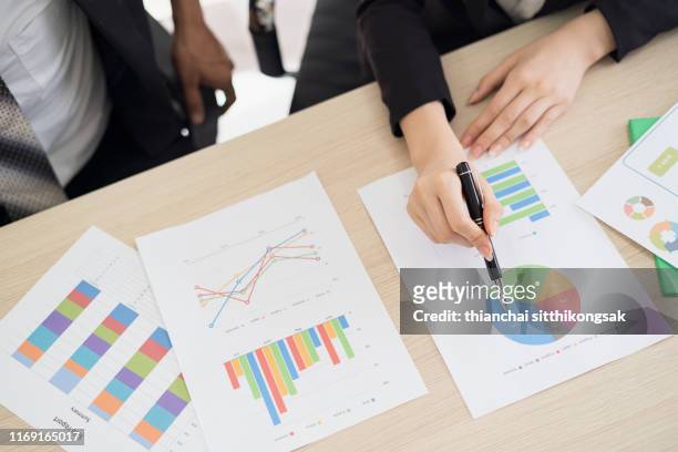 discussing paperwork of business strategy - business strategy stock pictures, royalty-free photos & images